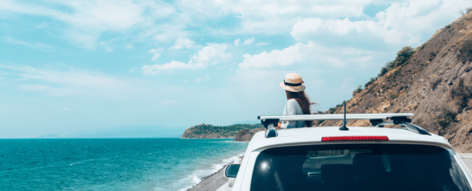 Una mujer en un coche, mirando el mar